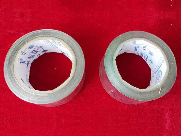 Two reels of anti-splash tapes on red background.
